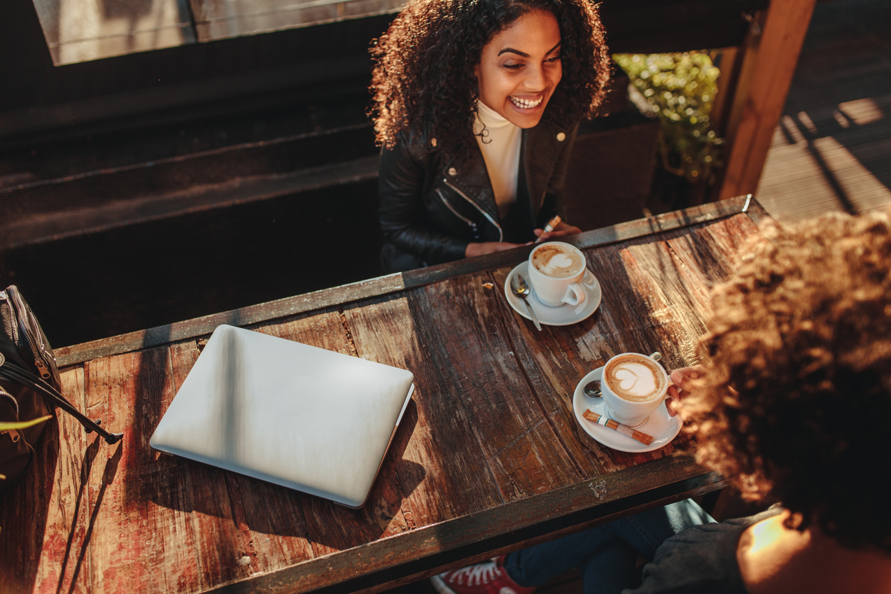 Two Women Talking over Coffee at a Coffee Shop